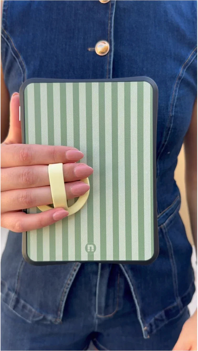 Hand holding tablet case with green vertical stripes and yellow grip strap