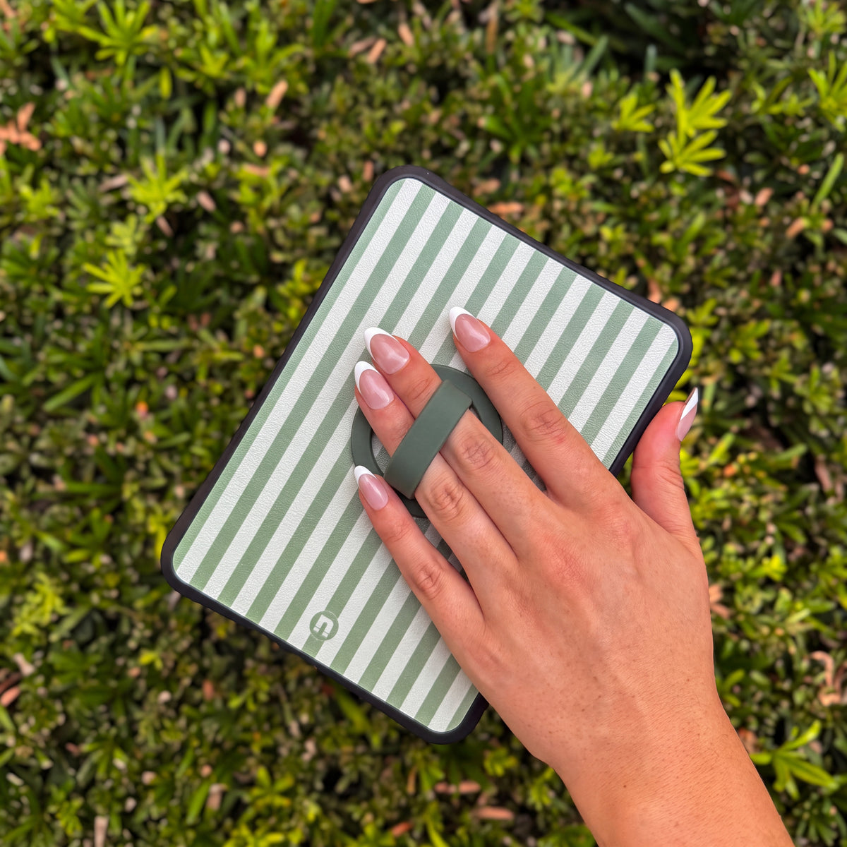 Hand holding a Bondi case by the grip: Hunter Green Grip on a Green Stripes case